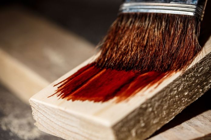 oiling a piece of floor board to repairs the floors in Geelong oiling a piece of floor board to repairs the floors in Geelong